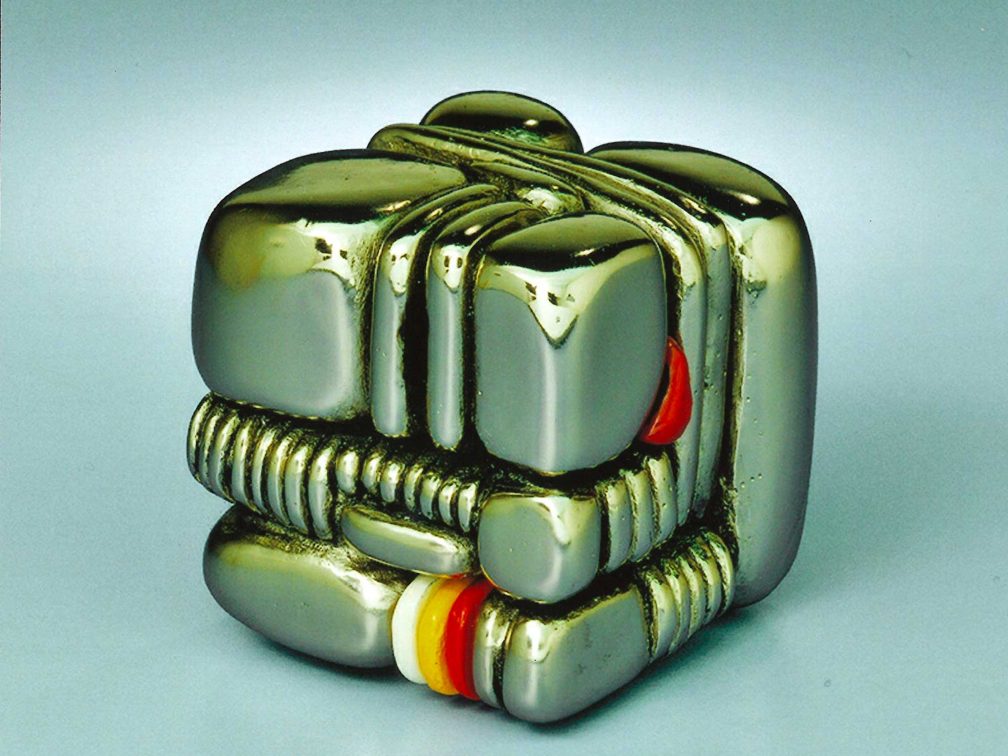 QUASI CUBO 1992, ottone cromato con inserti smaltati. Multiplo 1/10, cm. 7x7x7